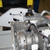 Connector Install Tool locates on the Trunion Pallet Arm and the operator uses a DC gun to run down/push the Connector into the Transmission.