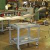 This mobile projection weld table splices together the end of an old steel roll and the start of a new steel roll which eliminates the need to setup/re-feed the stamping machines.